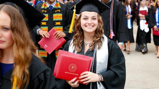 Student at graduation with honors cords